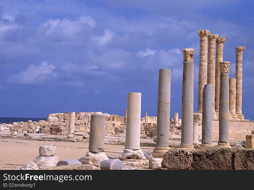 A ray of sunlight illuminates some columns in the archaeological site of Sabrata. A ray of sunlight illuminates some columns in the archaeological site of Sabrata