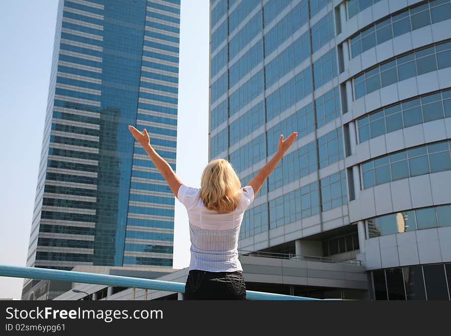 Business woman standing against a background of buildings