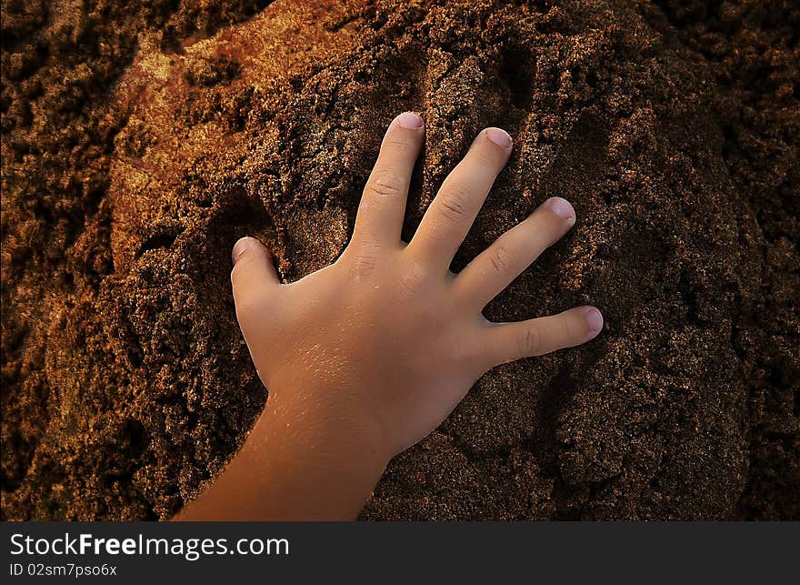 Hand on sand