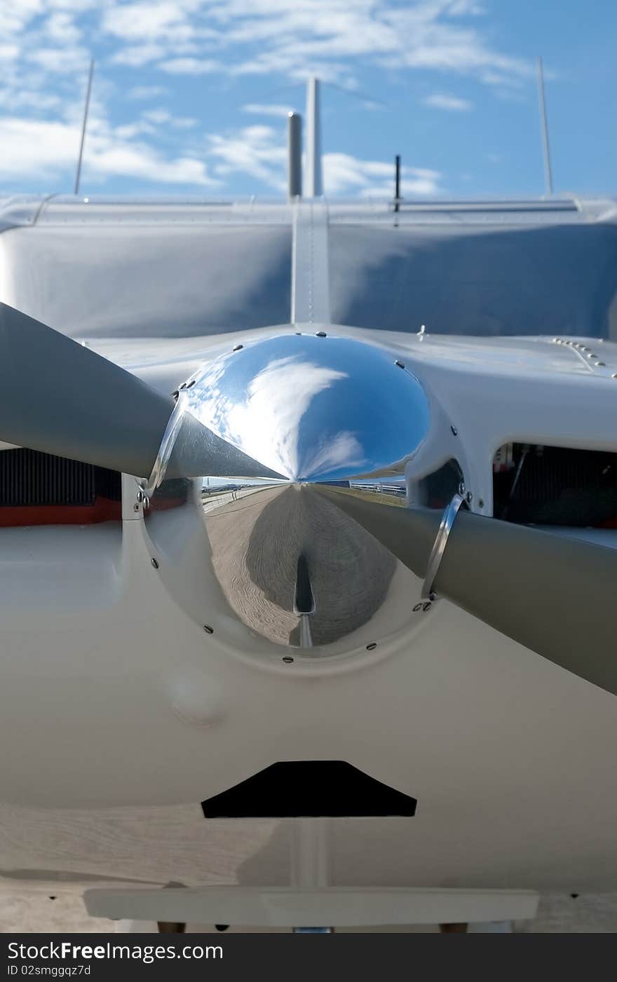 Reflections on a chromed light aircraft propeller nose cone