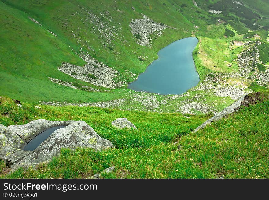 Alpine lake in a green valley