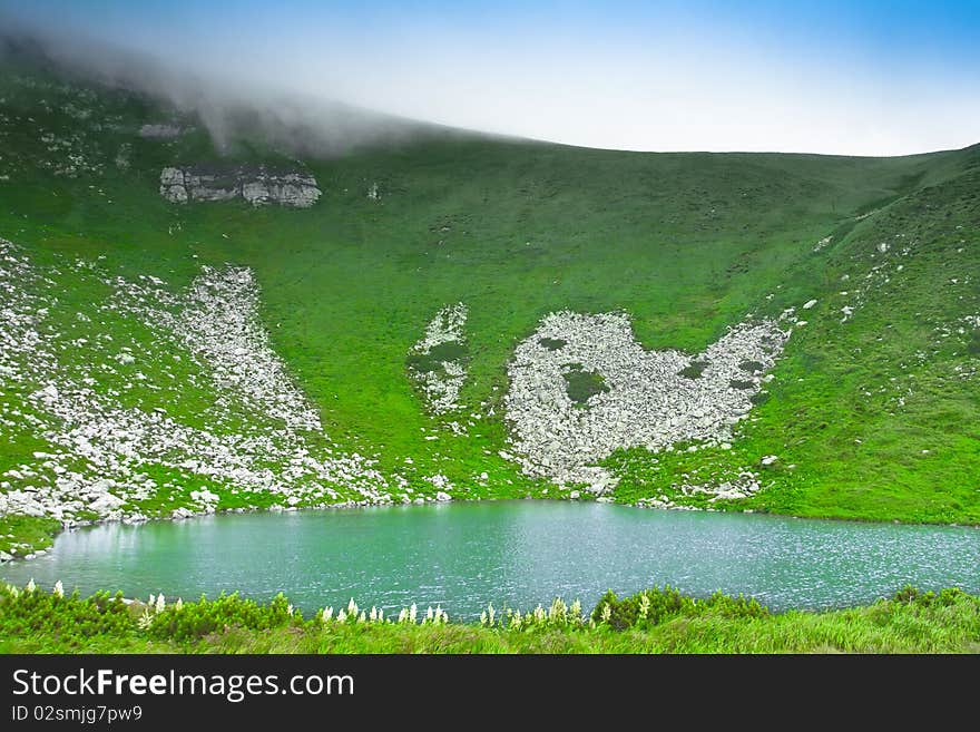 Blue mountain lake in the clouds