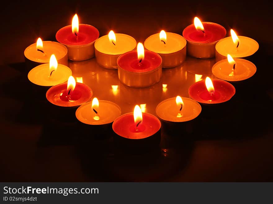 Fourteen lighting little candles in form of heart