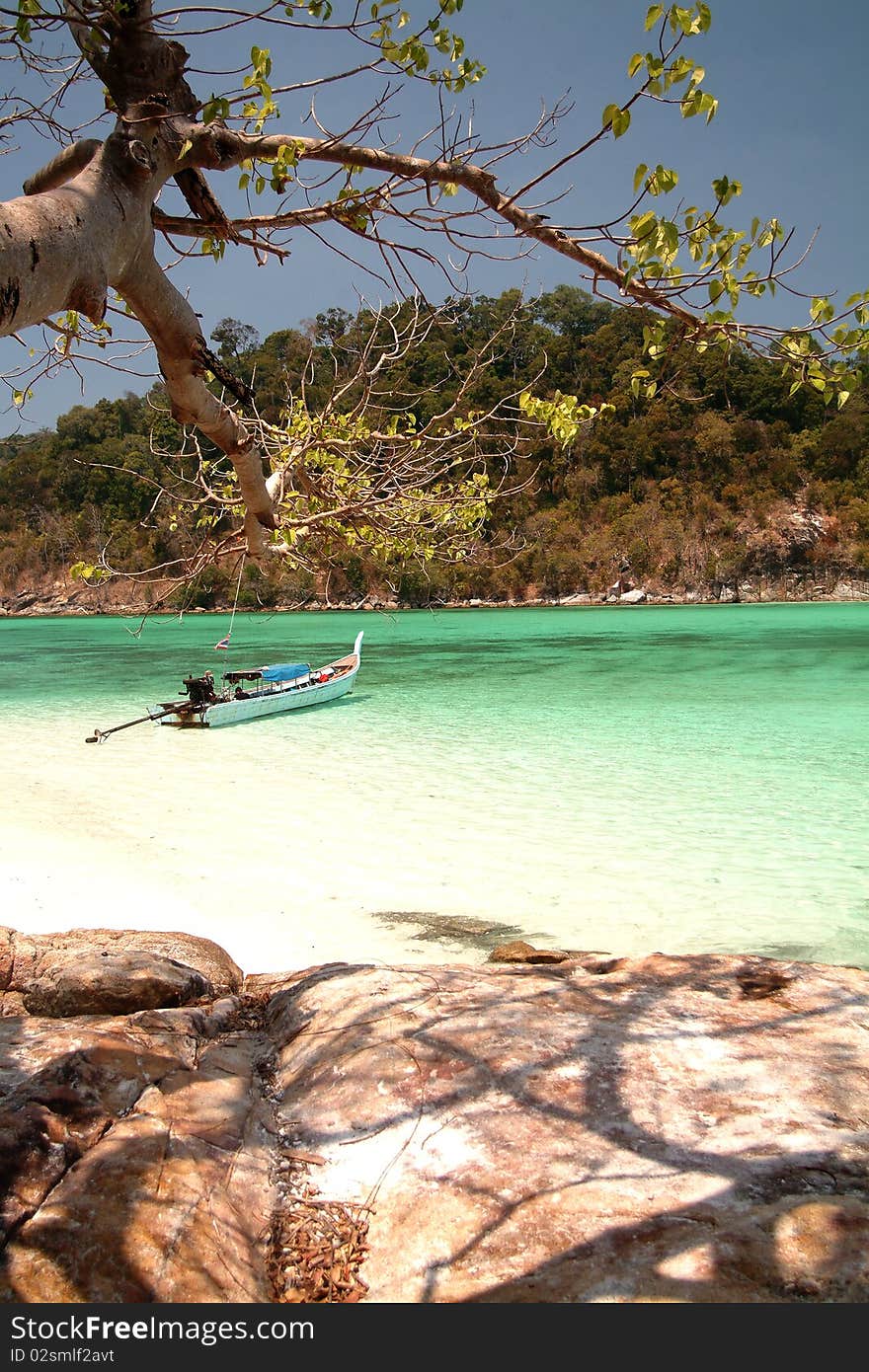 Longtail boat waiting  traveller in the Beautiful  sea at Koh Ba Jum pa in Tarutao Marine National park , Southern of Thailand. Longtail boat waiting  traveller in the Beautiful  sea at Koh Ba Jum pa in Tarutao Marine National park , Southern of Thailand