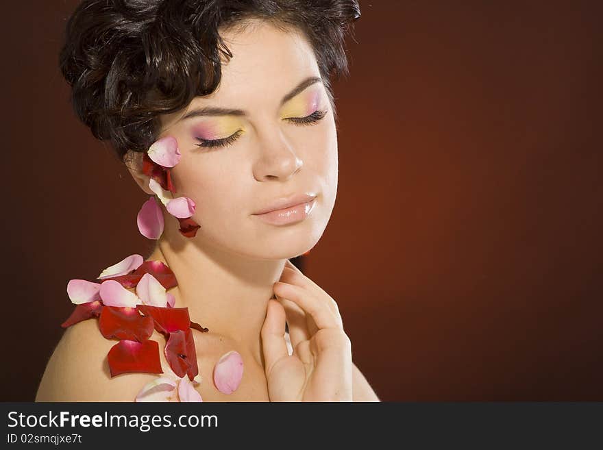 Portrait of a girl with beautiful make-up and rose petals. Portrait of a girl with beautiful make-up and rose petals