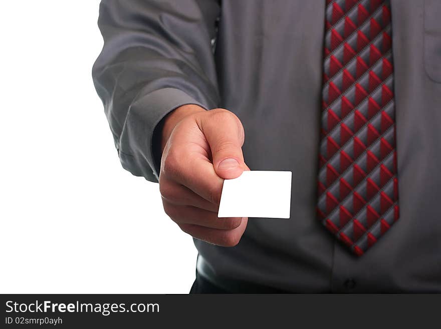 The businessman in a grey shirt and a tie stretches out a business card.