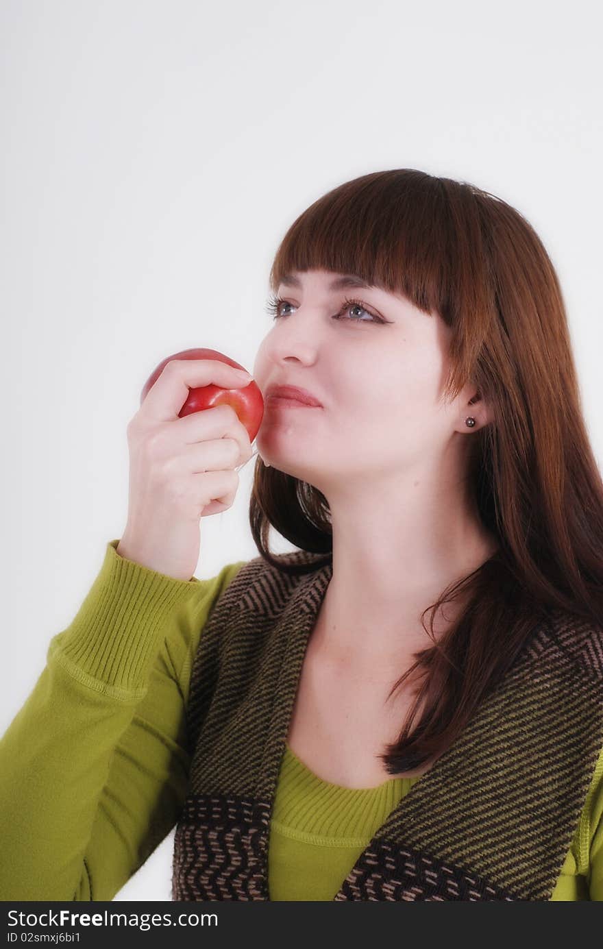 Girl is biting a juicy apple. Girl is biting a juicy apple