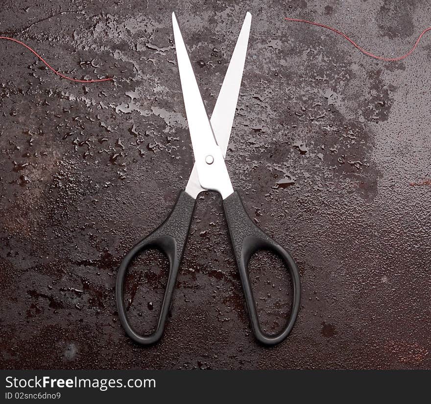 Scissors on rusty metal background. Scissors on rusty metal background