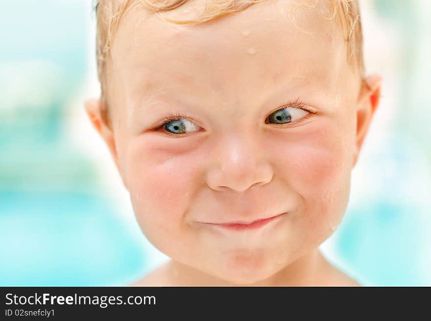 Portrait of smiling sly cute boy having a fun closeup