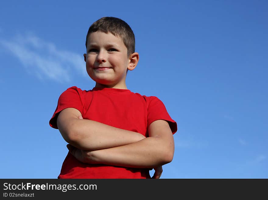 8 years old boy with good humoured. Boy crossed his arm. 8 years old boy with good humoured. Boy crossed his arm.