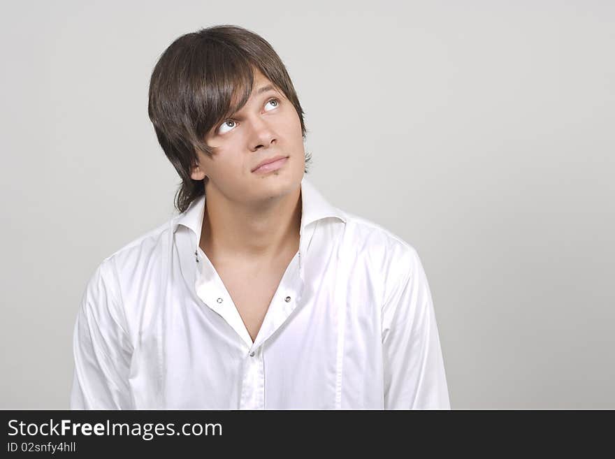 Portrait of young businessman on grey background