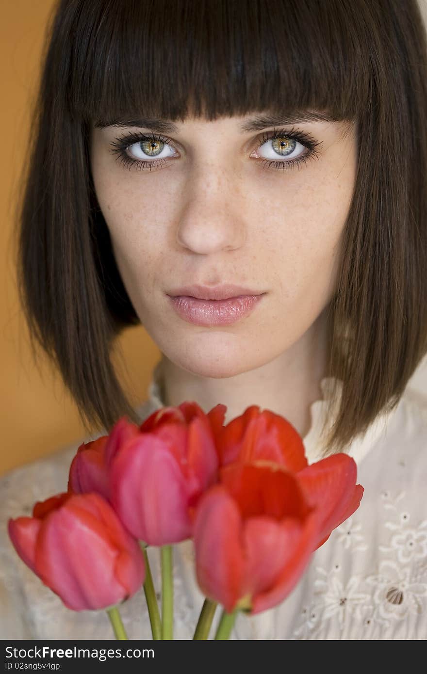 Young beautiful woman holding bouquet of tulips. Young beautiful woman holding bouquet of tulips