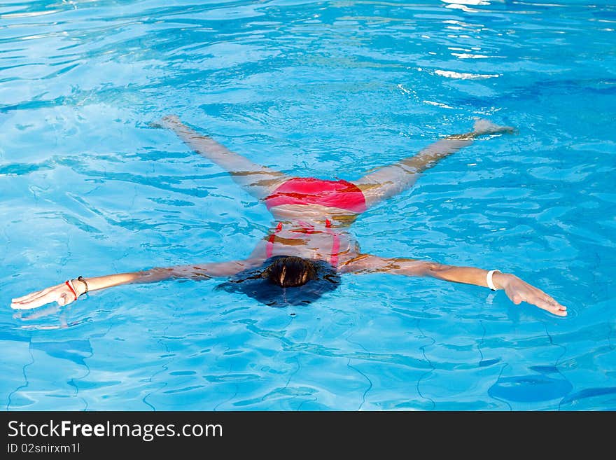 Young woman learn to swimming. Float on the water. Young woman learn to swimming. Float on the water