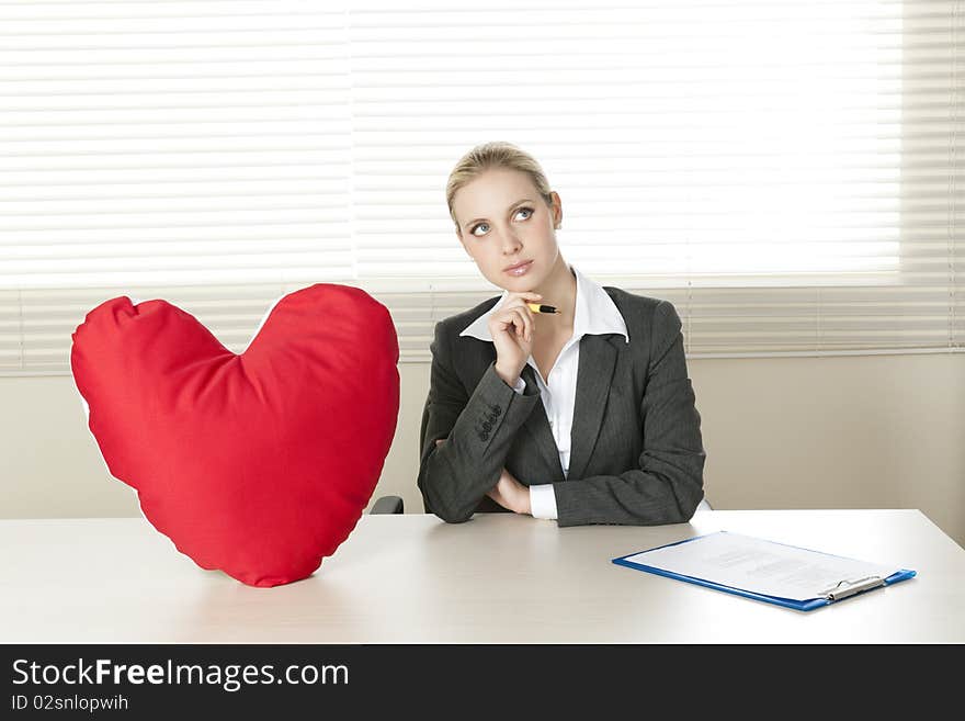 Young businesswoman dreaming of her Valentine date. Young businesswoman dreaming of her Valentine date