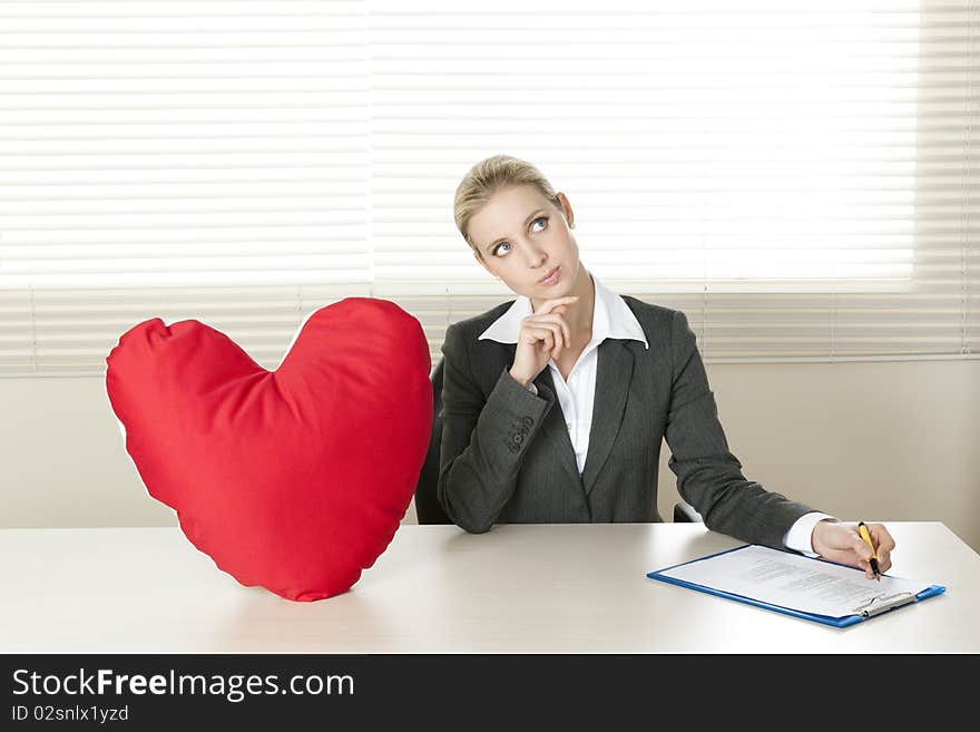 Young businesswoman dreaming of her Valentine date. Young businesswoman dreaming of her Valentine date