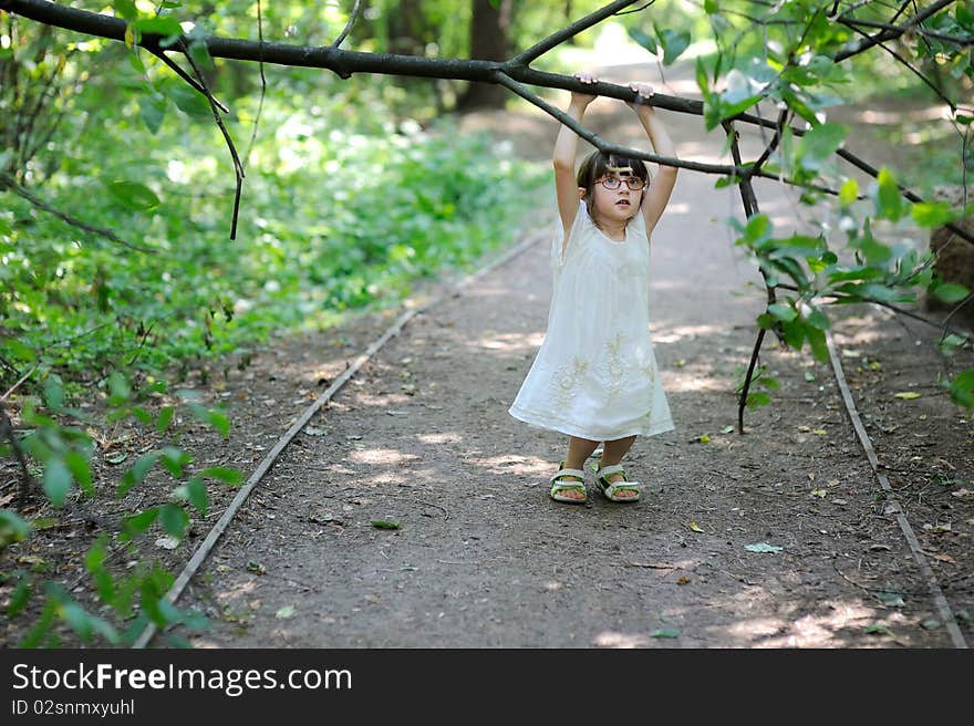 Nice toddler girl in the summer forest