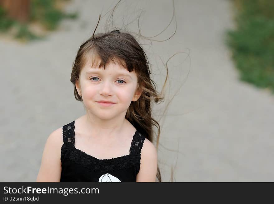 Adorable toddler girl with very long dark fluttering hair. Adorable toddler girl with very long dark fluttering hair