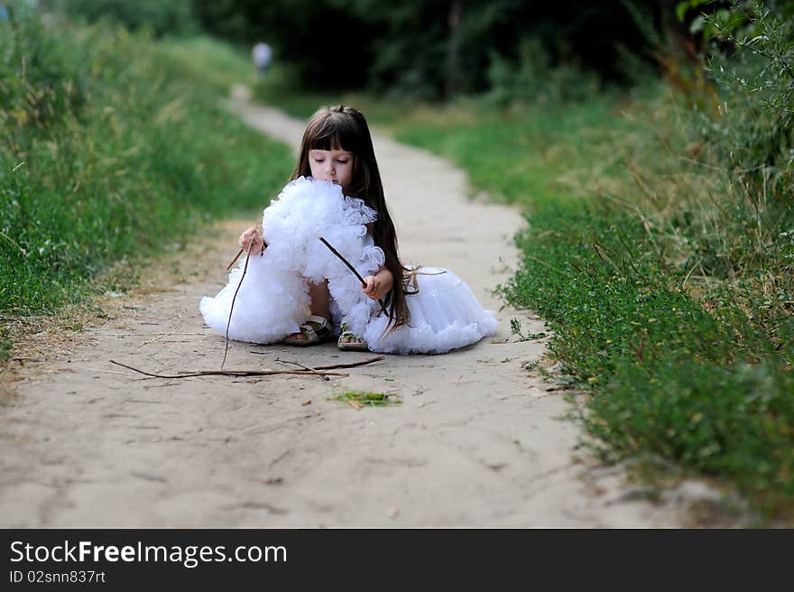 Adorable toddler girl in white tutu skirt