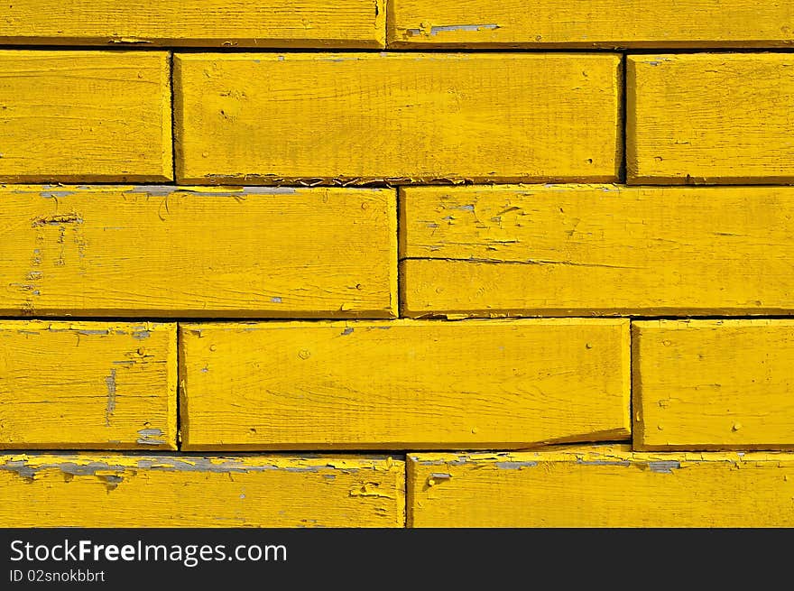 The yellow wooden wall of old house. The yellow wooden wall of old house