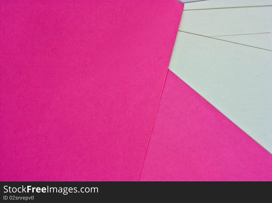 Pink and white paper spread out to form a pattern