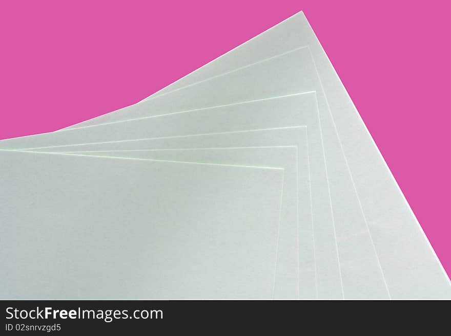 Pink and white paper spread out to form a pattern. Pink and white paper spread out to form a pattern