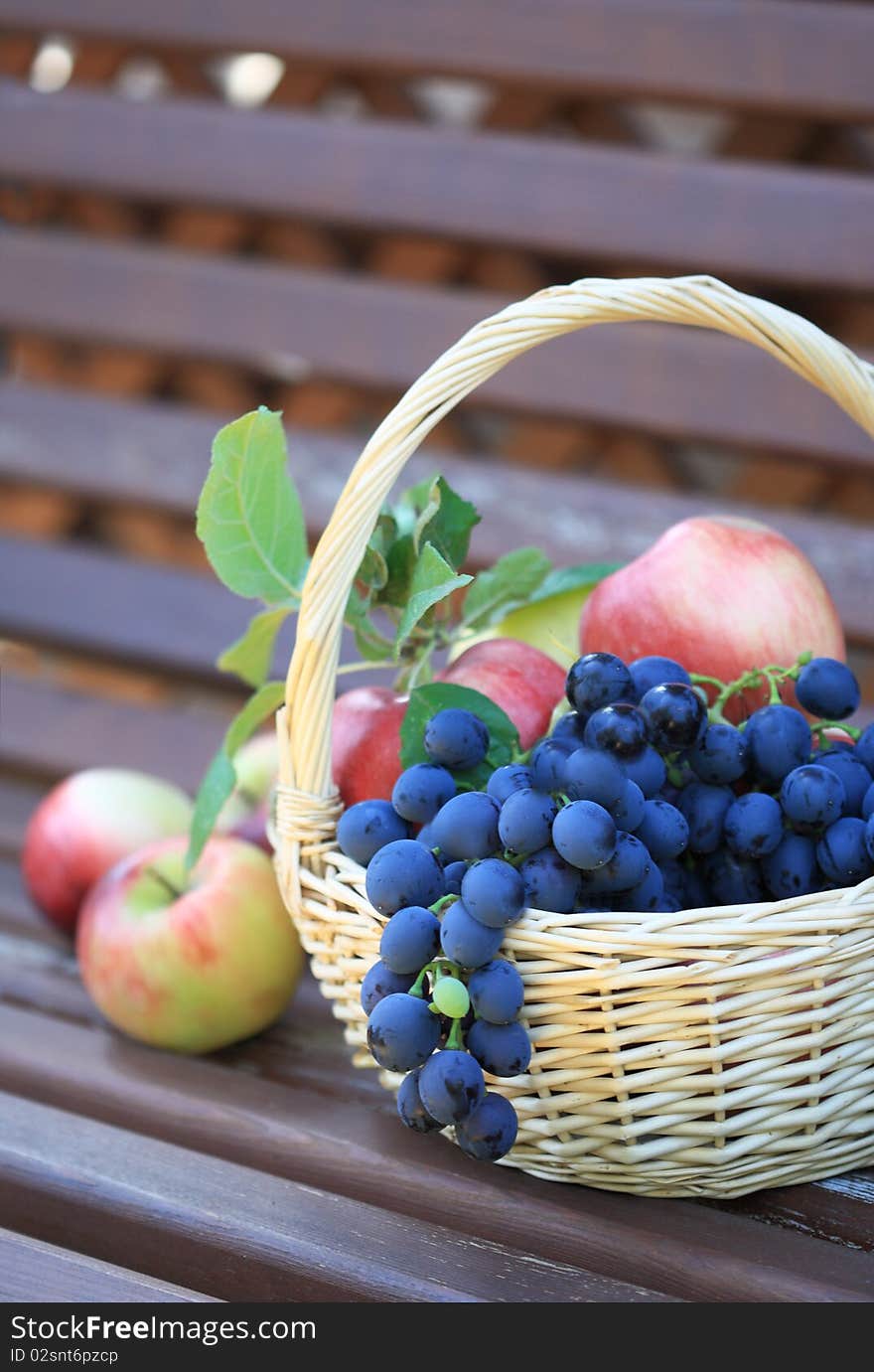 Tasty grapes and apples in the basket. Tasty grapes and apples in the basket