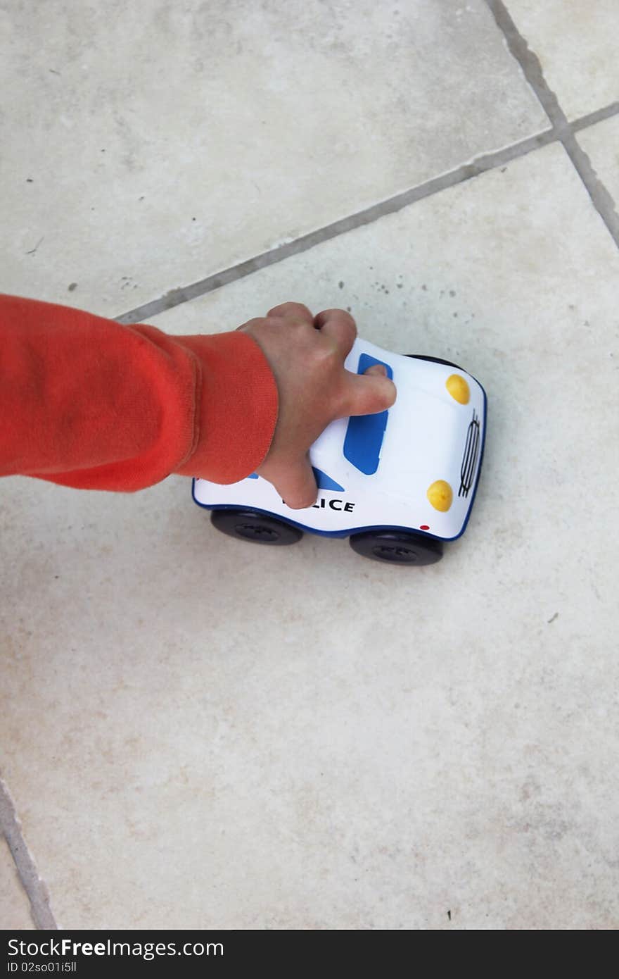 Boy playing with a toy car