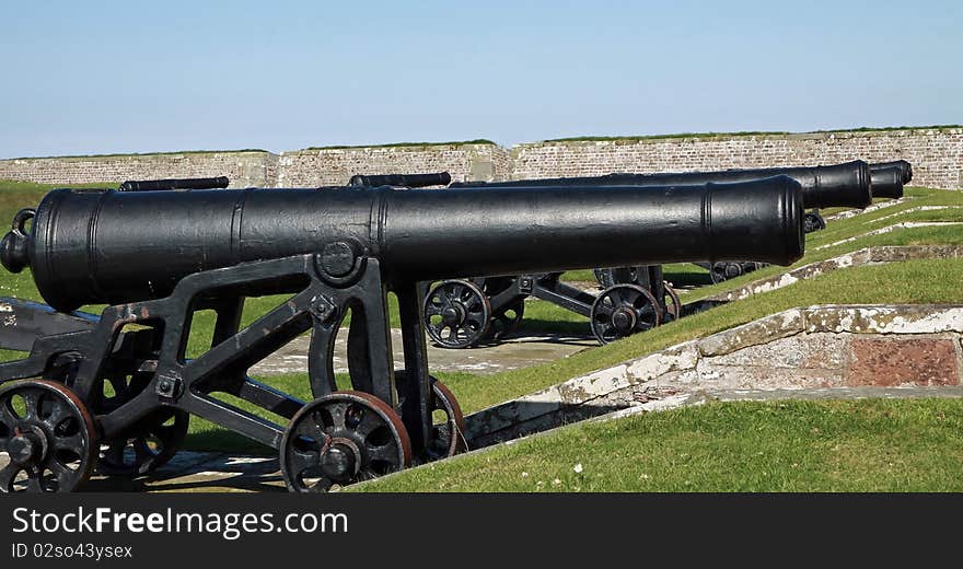 Old cannons looking out   from  the battlements of fort george invernesshire. Old cannons looking out   from  the battlements of fort george invernesshire