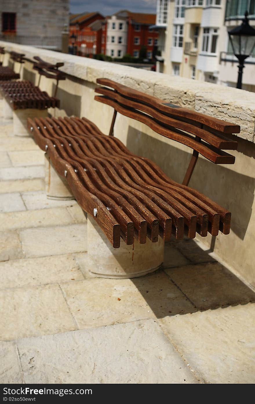 Modern timber wavy seating on a footpath