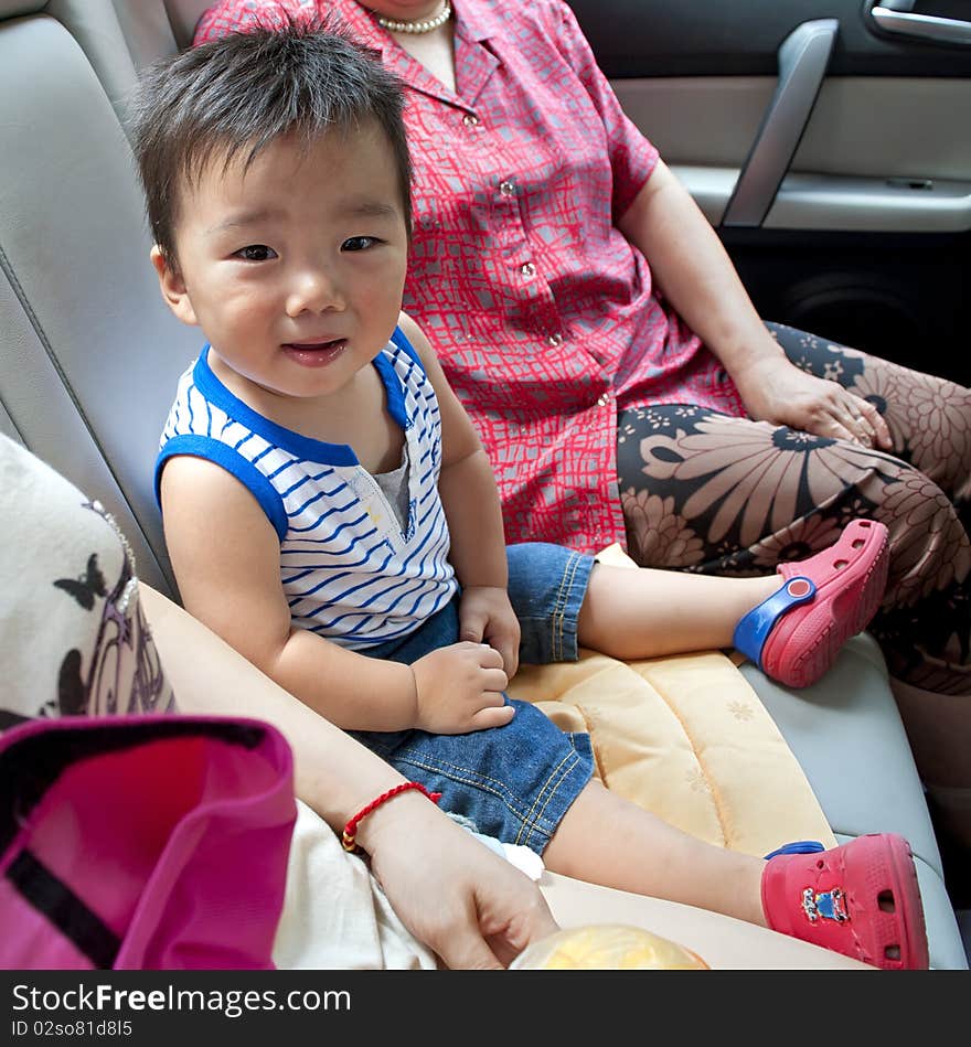 A cute baby inside a car.