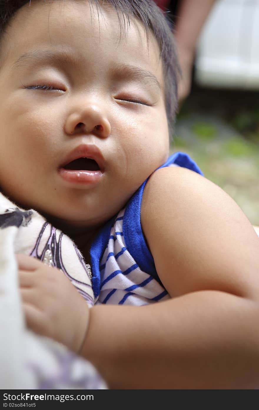 Happy baby sleeping in the arms of his mother. Happy baby sleeping in the arms of his mother