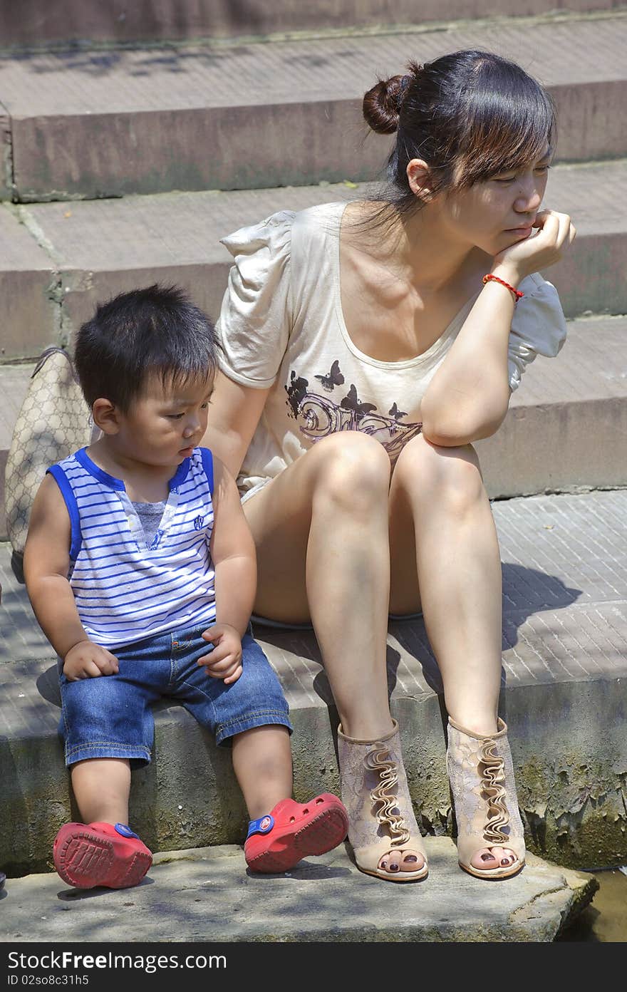 A baby playing with his mother in garden. A baby playing with his mother in garden.