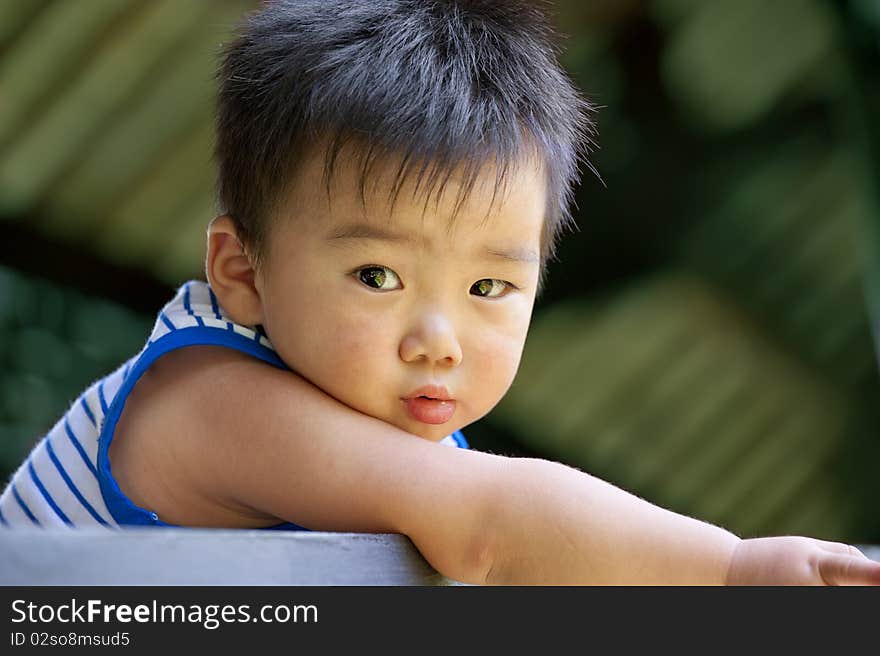 A playing baby in a garden.