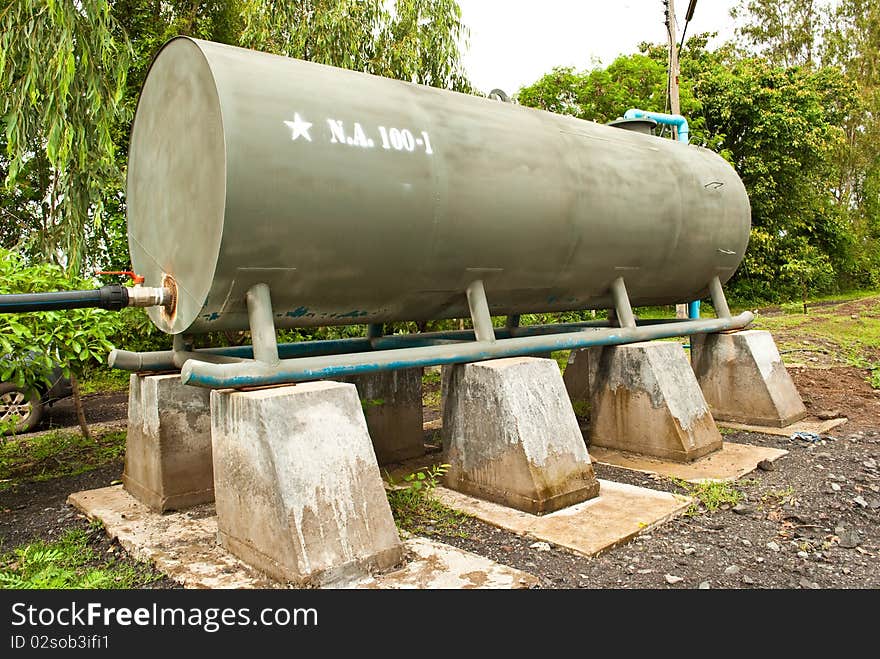 Big green cisterns water with background green of tree