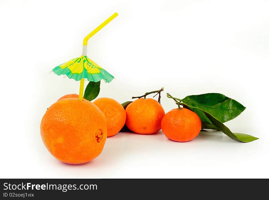 Fresh orange drink with straw, more oranges in the background