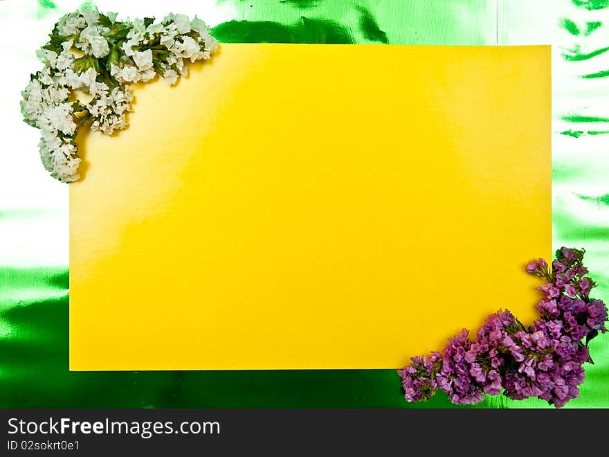 Yellow paper blank on green with flowers design. Yellow paper blank on green with flowers design