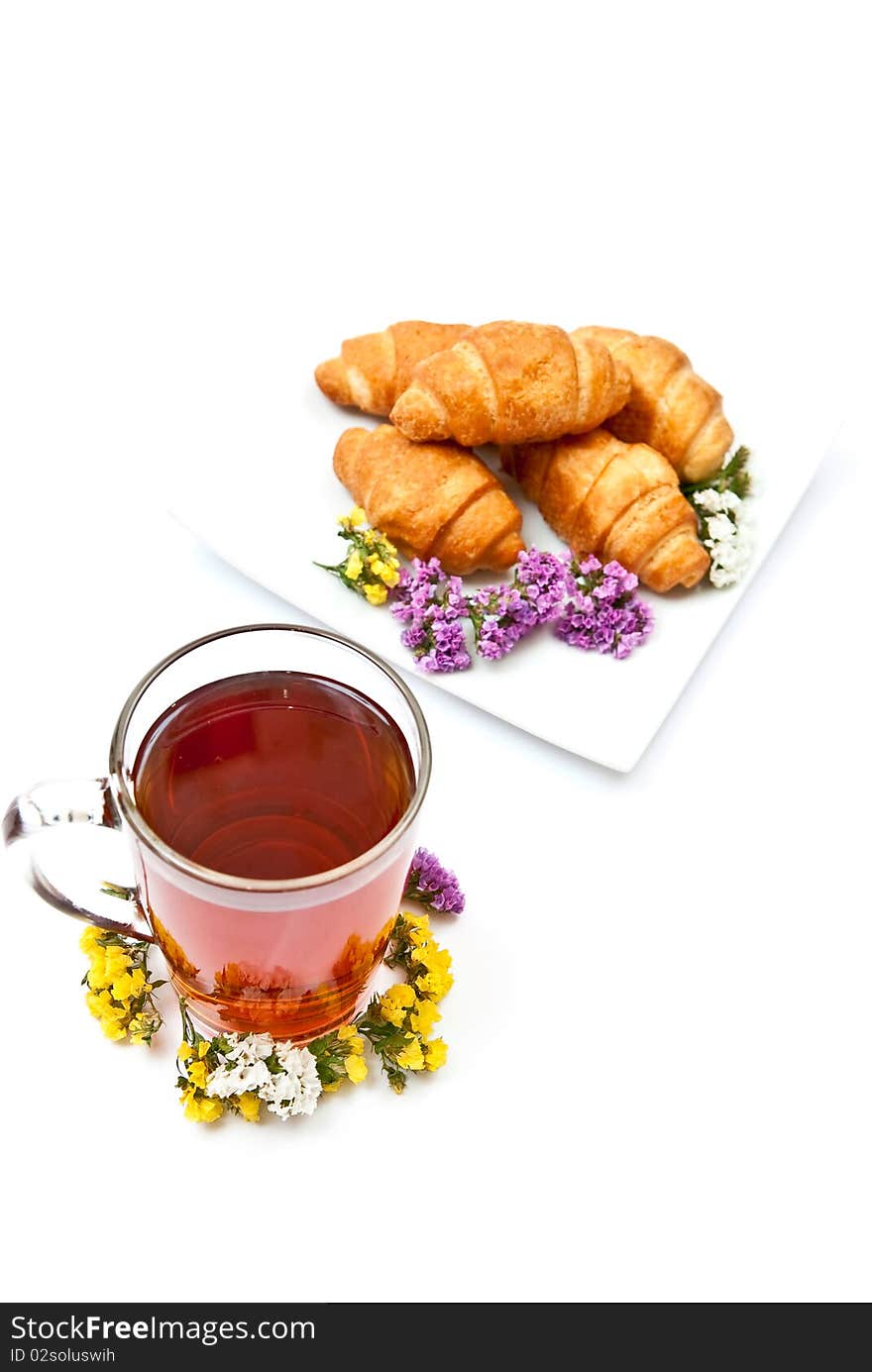 Tea and croissants with flowers design isolated on white