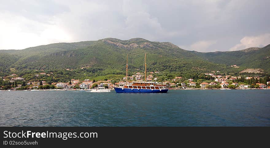 Panoramic view with summer mediterranean landscape, mountains , small town and ship in Boca Cotorska (Montenegro). Panoramic view with summer mediterranean landscape, mountains , small town and ship in Boca Cotorska (Montenegro)