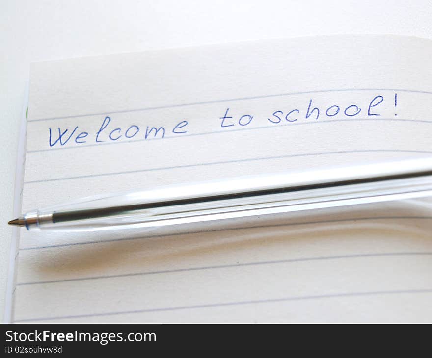 Workbook and a pen on a white background. Workbook and a pen on a white background