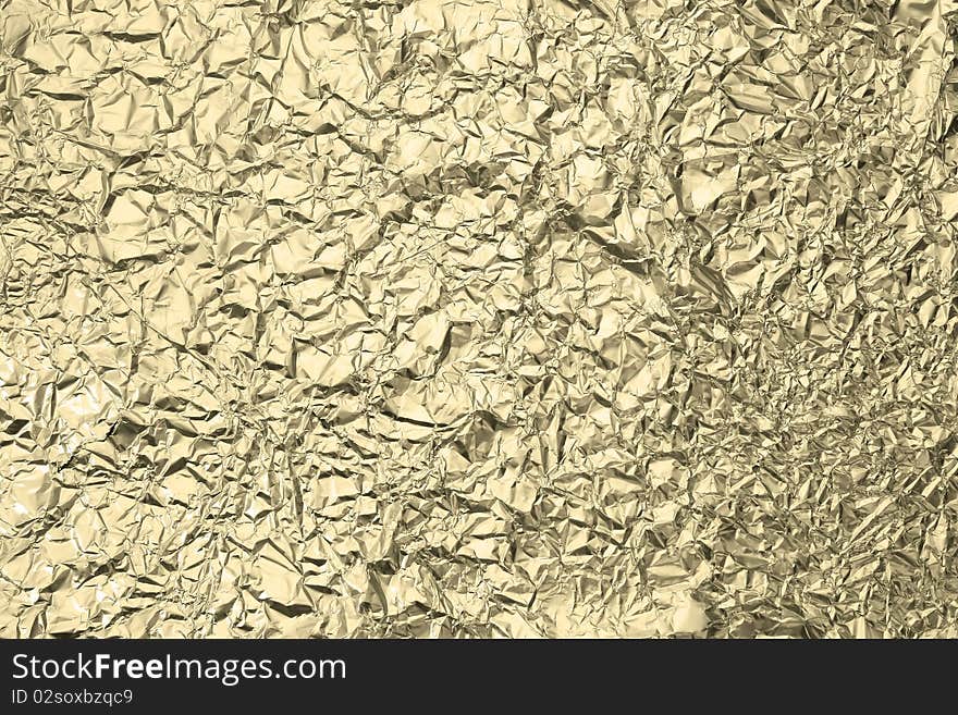 Pattern of Wrinkled Gold Aluminum Foil Paper using as background