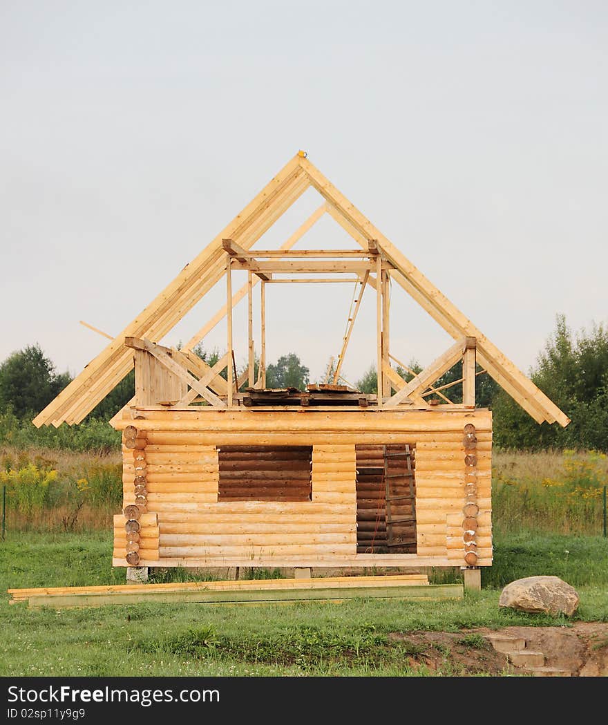 New log construction in green meadow. New log construction in green meadow..