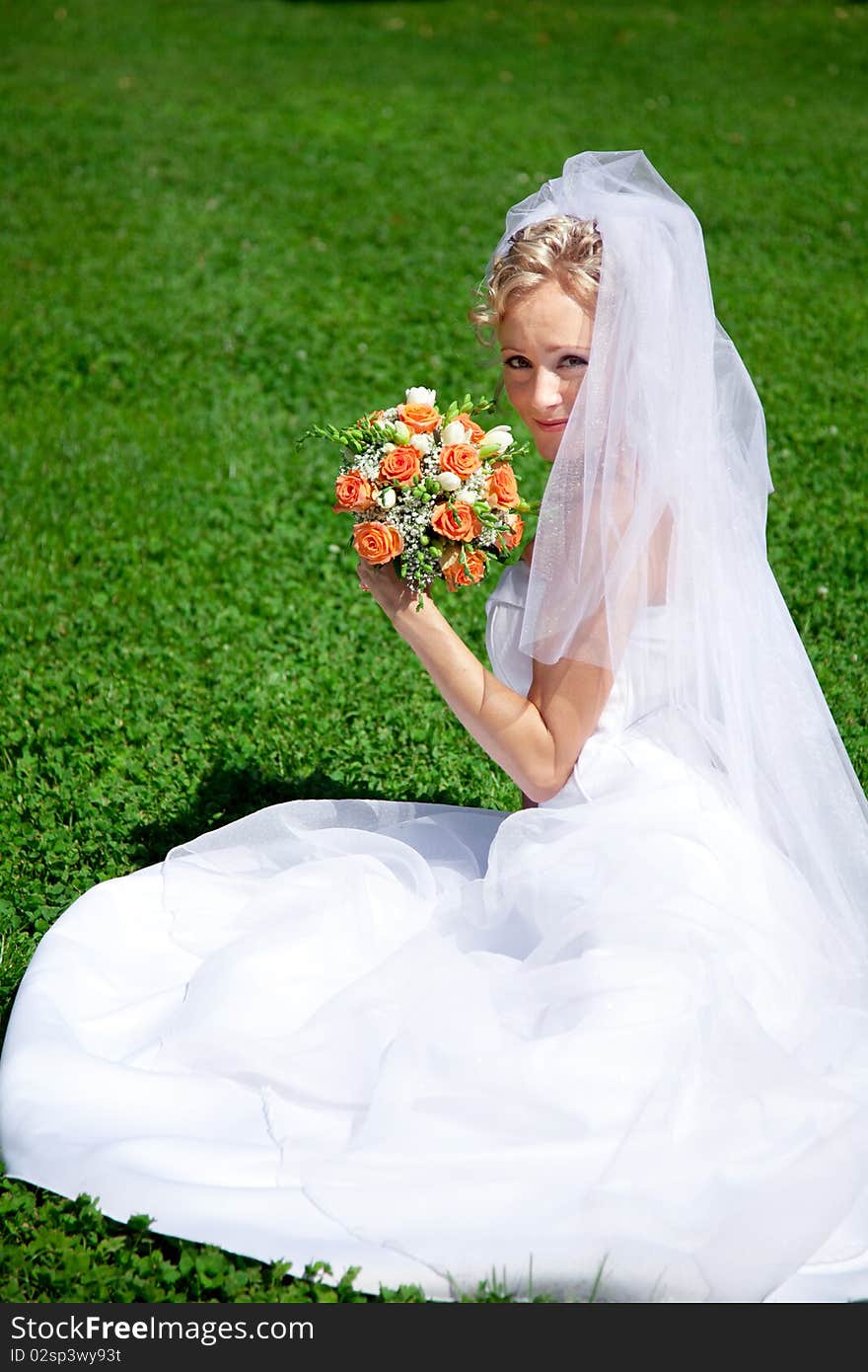 Young beautiful bride with wedding bouquet. Young beautiful bride with wedding bouquet