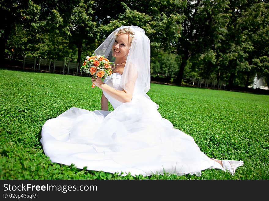 Young beautiful  bride with wedding bouquet. Young beautiful  bride with wedding bouquet