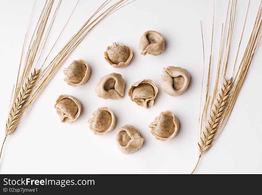 Fresh raw whole grain capeletti isolated on white close up. Fresh raw whole grain capeletti isolated on white close up