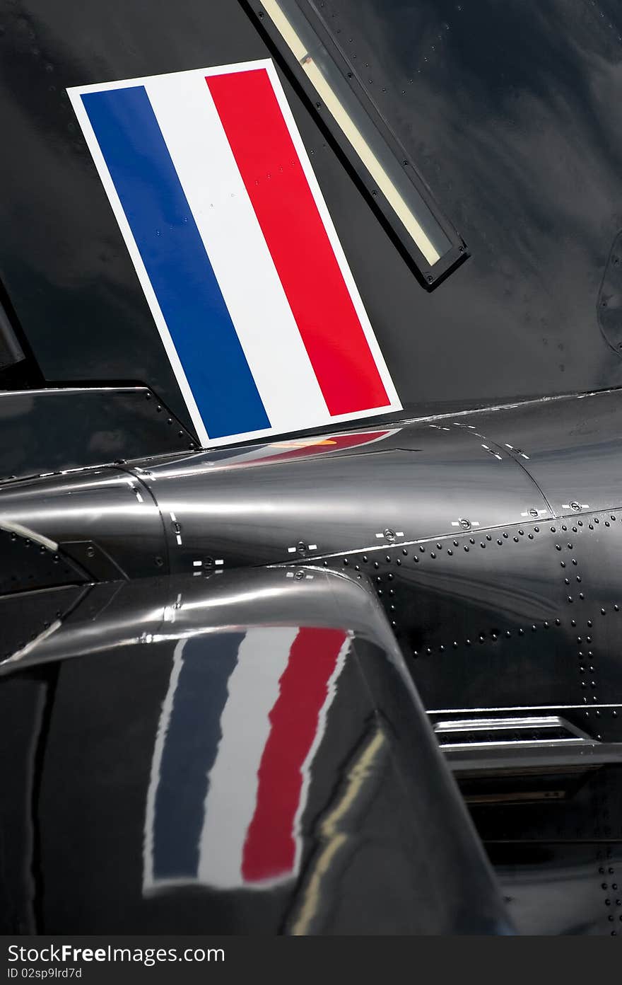 Flag of the netherlands and its reflection on an aircraft fuselage. Flag of the netherlands and its reflection on an aircraft fuselage