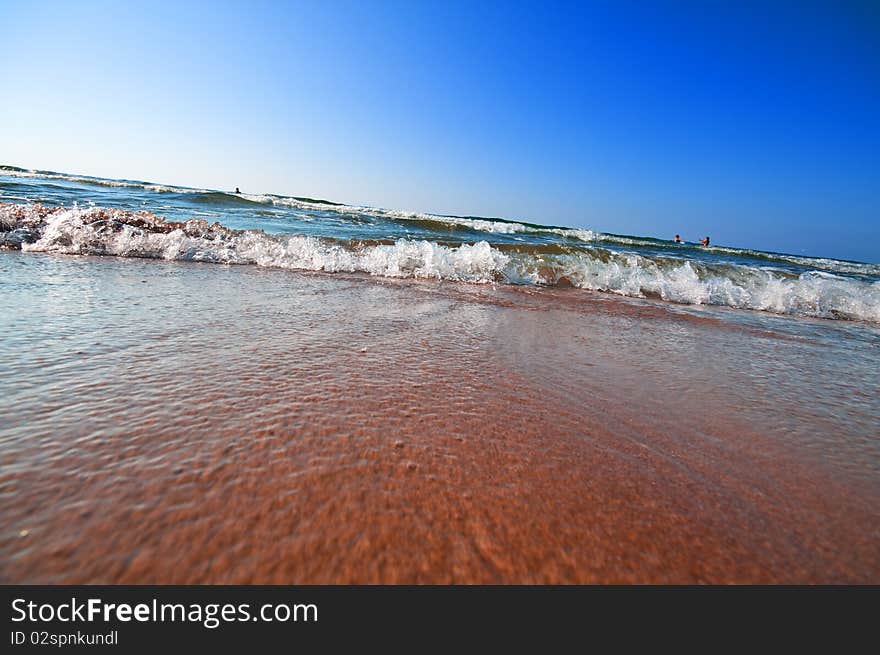 Seashore with waves and foam