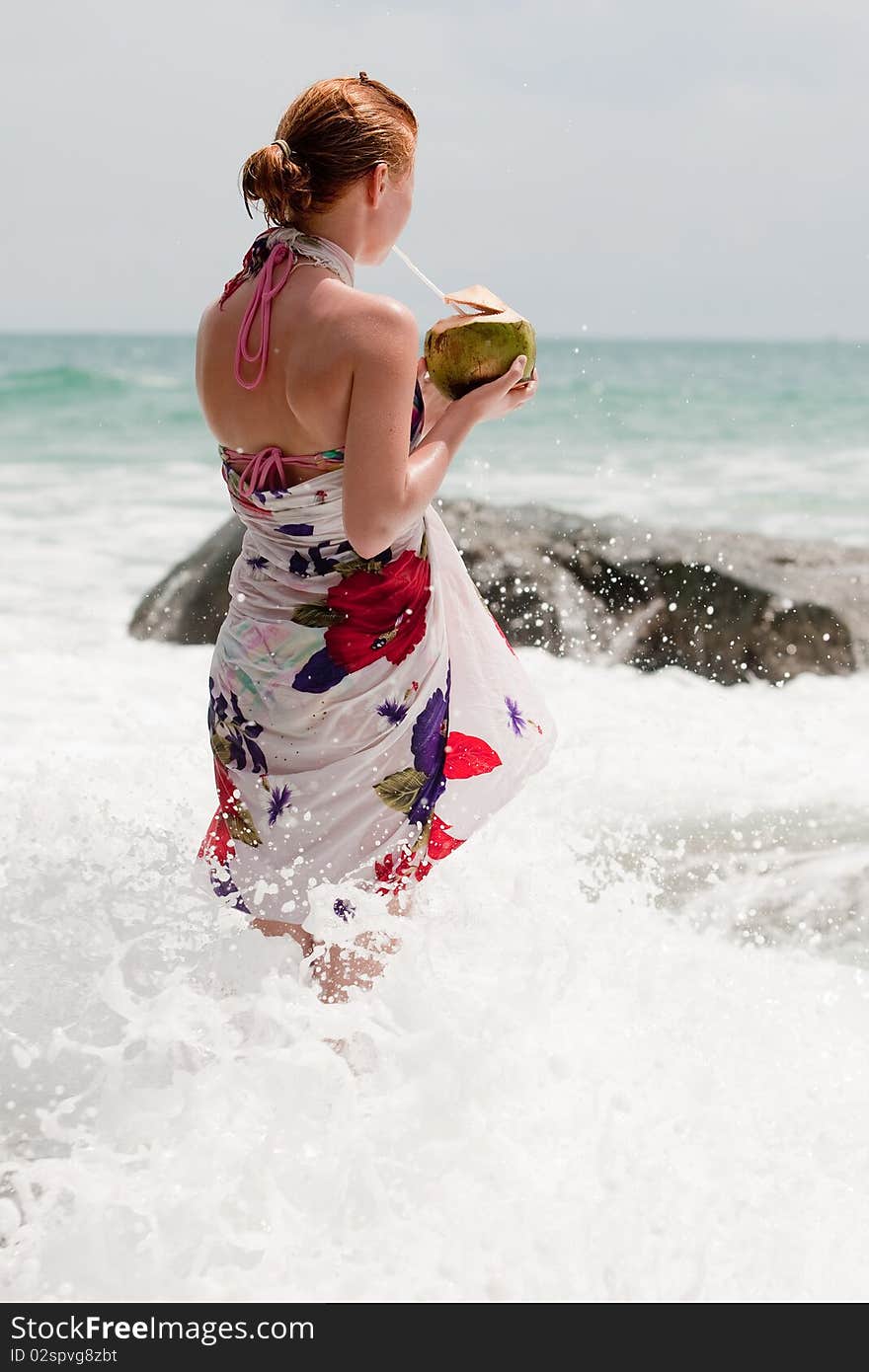 Vacation at the sea, teenager in bath clothing drink a coconut