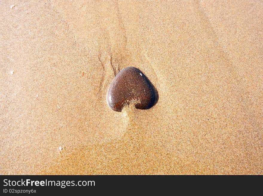 Heart-shaped stone on the seashore