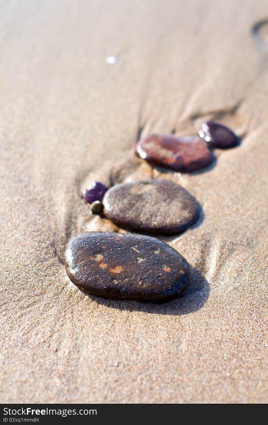 Stones on the seashore with reflections on water. Stones on the seashore with reflections on water