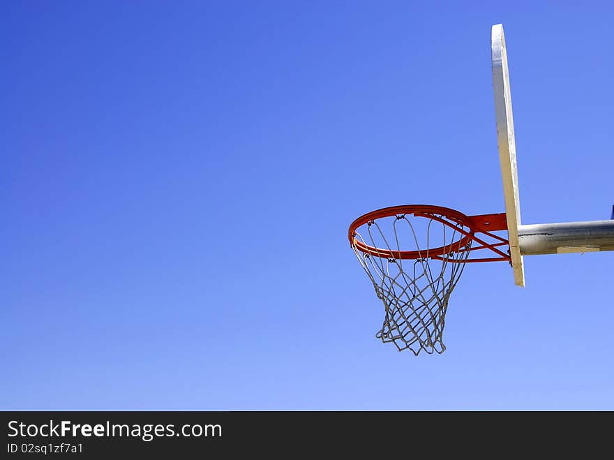 Basketball hoop with blue sky in the background